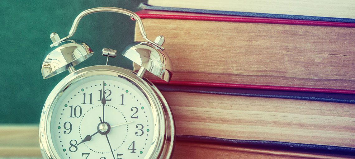 Stack of books with clock